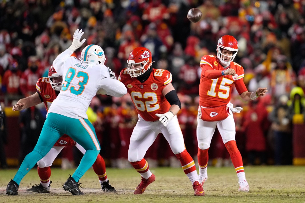 Kansas City Chiefs quarterback Patrick Mahomes throws as guard Joe Thuney covers against Miami Dolphins defensive tackle Da'Shawn Hand.