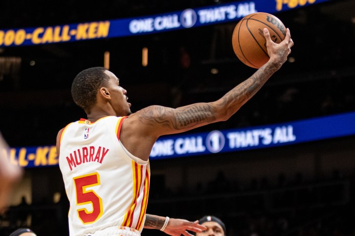 NBA: Orlando Magic at Atlanta Hawks Atlanta Hawks guard Dejounte Murray lays in the ball against Orlando Magic during fourth quarter at State Farm Arena.