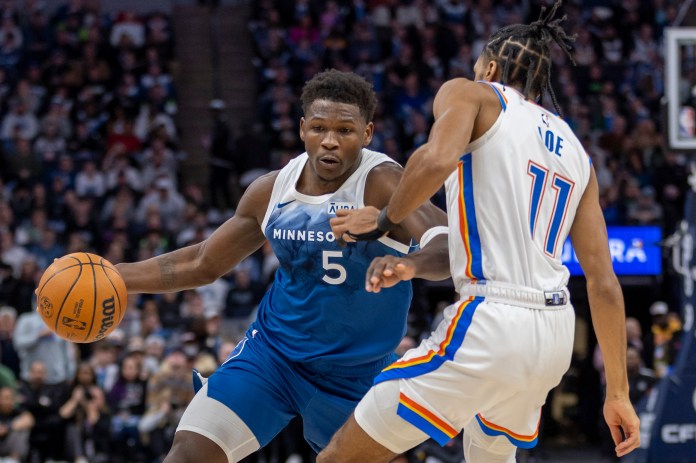 NBA: Oklahoma City Thunder at Minnesota Timberwolves Timberwolves' Anthony Edwards dribbles as Thunder's Isaiah Joe defends.