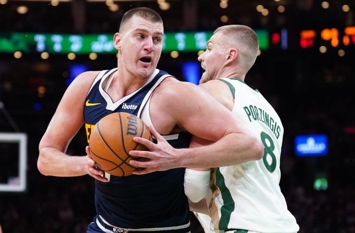 NBA: Denver Nuggets at Boston Celtics Denver Nuggets center Nikola Jokic works the ball around Boston Celtics center Kristaps Porzingis in the second quarter at TD Garden.
