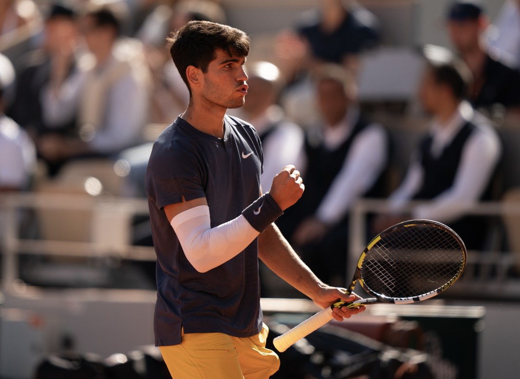 Carlos Alcaraz reacts to winning a big point against Alexander Zverev in the French Open final.
