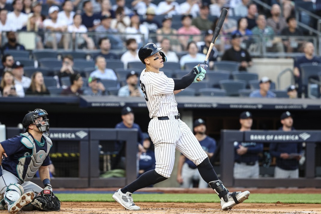 New York Yankees center fielder Aaron Judge (99) hits a two-run home run in the first inning against the Seattle Mariners at Yankee Stadium on May 22, 2024.