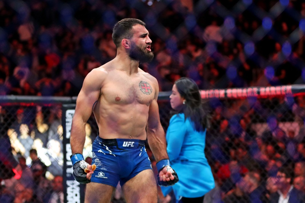 Benoit Saint Denis (blue gloves) reacts after defeating Matt Frevola (red gloves) during UFC 295 at Madison Square Garden on November 11, 2023.