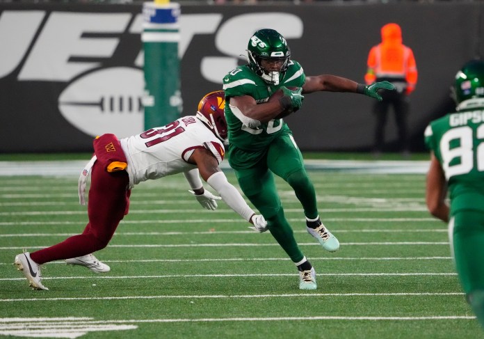 New York Jets running back Breece Hall (20) gets a late fourth-quarter first down against the Washington Commanders at MetLife Stadium on December 24, 2023.