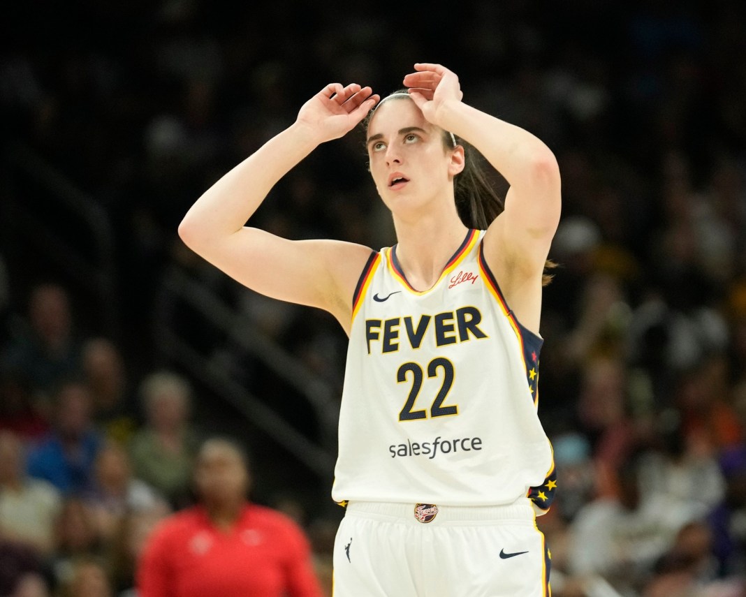 Indiana Fever guard Caitlin Clark (22) adjusts her headband during the first quarter against the Phoenix Mercury at Footprint Center on June 30, 2024, in Phoenix.
