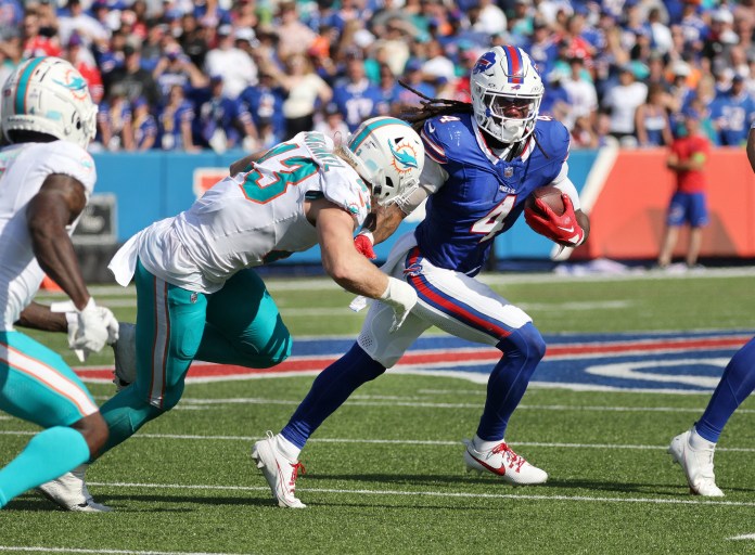 Bills running back James Cook looks for room to run against the Dolphins during a game at Hard Rock Stadium.