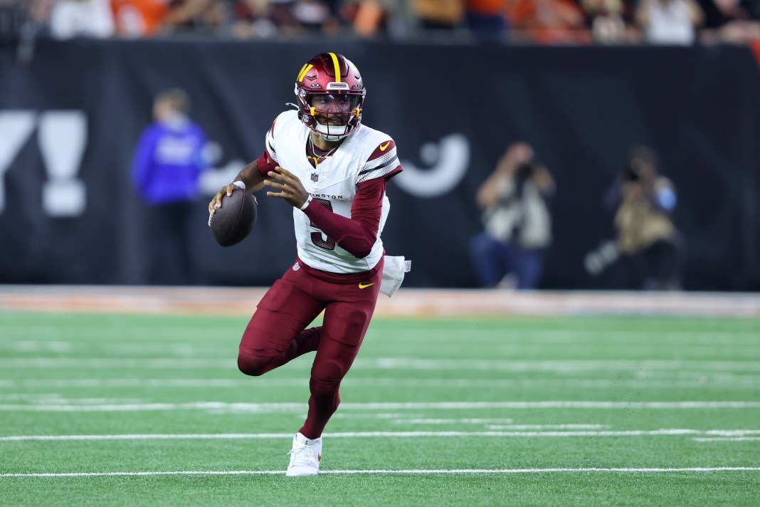 Washington Commanders quarterback Jayden Daniels (5) runs with the ball during the fourth quarter against the Cincinnati Bengals at Paycor Stadium on September 23, 2024.