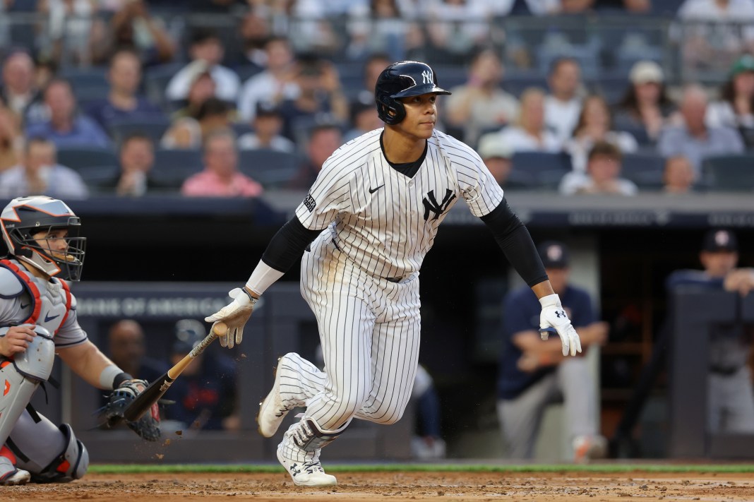 New York Yankees right fielder Juan Soto (22) follows through on an RBI infield single during the second inning against the Houston Astros at Yankee Stadium on May 8, 2024.