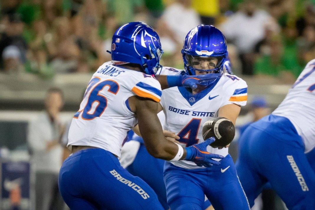 Boise State quarterback Maddux Madsen hands the ball off to running back Sire Gaines as the Boise State Broncos face the Oregon Ducks at Autzen Stadium in Eugene, Oregon, on September 7, 2024.