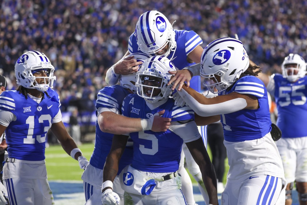 Brigham Young Cougars wide receiver Darius Lassiter (5) celebrates a touchdown with teammates