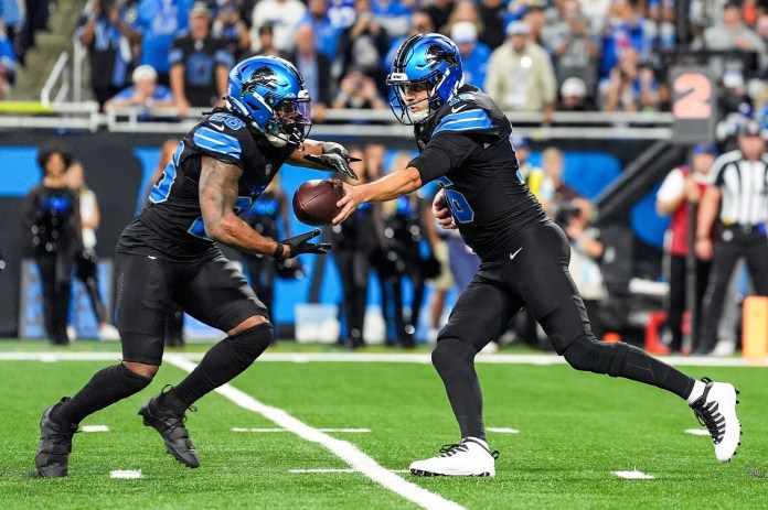 Detroit Lions quarterback Jared Goff (16) hands the ball to running back Jahmyr Gibbs (26) against Seattle Seahawks