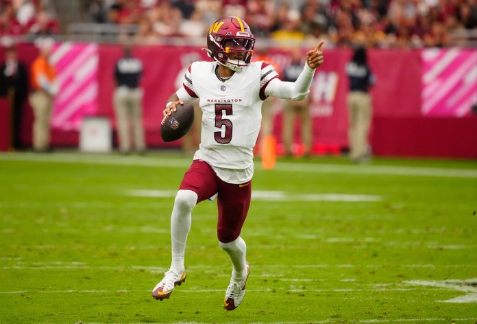 Commanders quarterback Jayden Daniels (5) looks for open receivers during the game against the Arizona Cardinals at State Farm Stadium in Glendale, Arizona, on September 29, 2024.