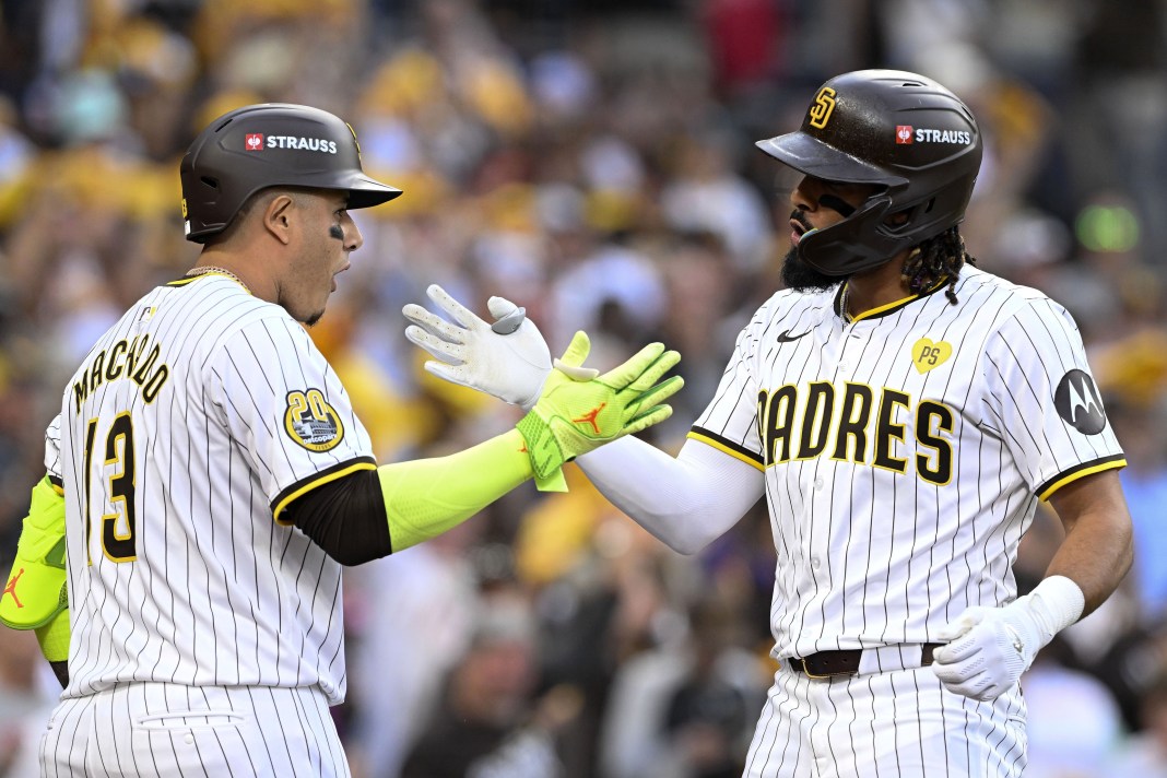 San Diego Padres outfielder Fernando Tatis Jr. (23) celebrates with third baseman Manny Machado (13) after hitting a two-run home run against the Atlanta Braves during the first inning of Game 1 of the Wildcard round at Petco Park on October 1, 2024.