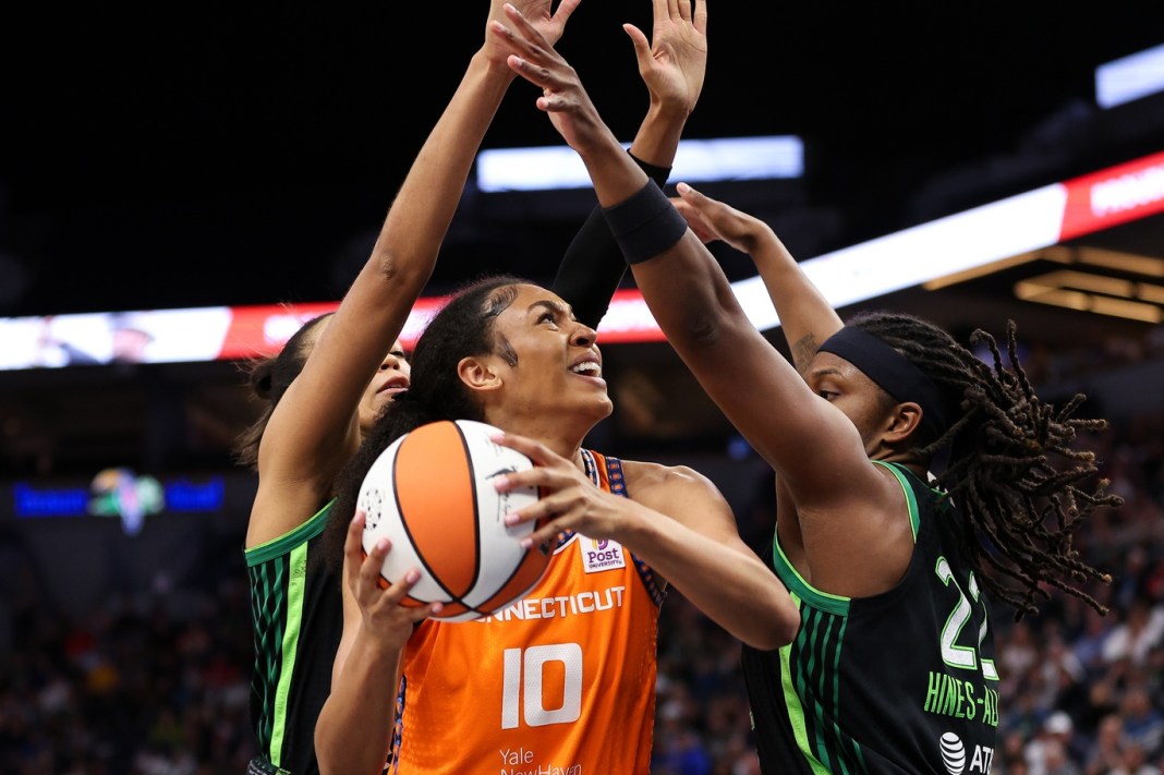 Connecticut Sun forward Olivia Nelson-Ododa (10) looks to shoot as Minnesota Lynx forward Napheesa Collier (24) and forward Myisha Hines-Allen (22) defend during the second half of Game 2 of the 2024 WNBA Semi-finals at Target Center on October 1, 2024.