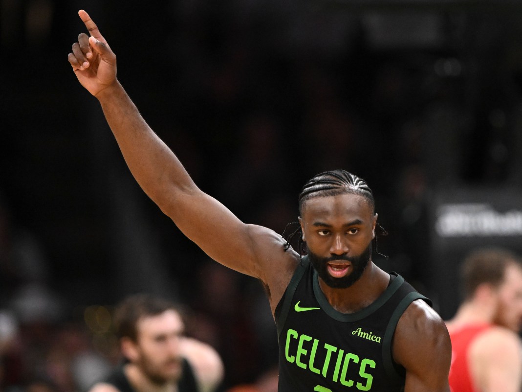 Boston Celtics guard Jaylen Brown points upward