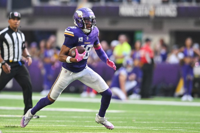 Minnesota Vikings wide receiver Justin Jefferson (18) runs the ball against the Detroit Lions during the fourth quarter at U.S. Bank Stadium.