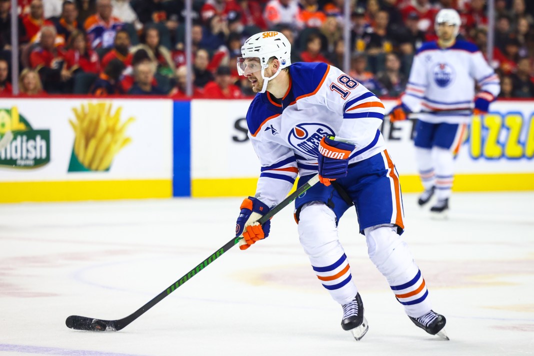 Edmonton Oilers left wing Zach Hyman (18) controls the puck against the Calgary Flames during the third period at Scotiabank Saddledome