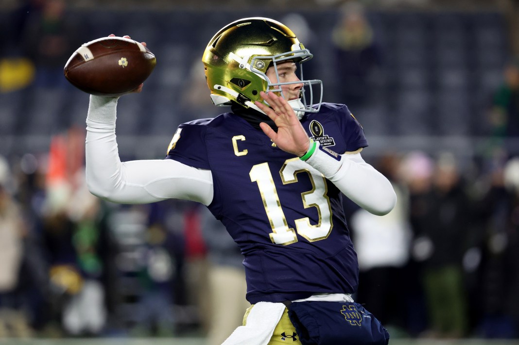 Notre Dame quarterback Riley Leonard (13) warms up before the first-round playoff game against the Indiana Hoosiers at Notre Dame Stadium on December 20, 2024.