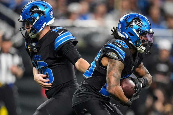 Detroit Lions quarterback Jared Goff (16) hands off the ball to running back Jahmyr Gibbs (26) during the first half at Ford Field on January 5, 2025.