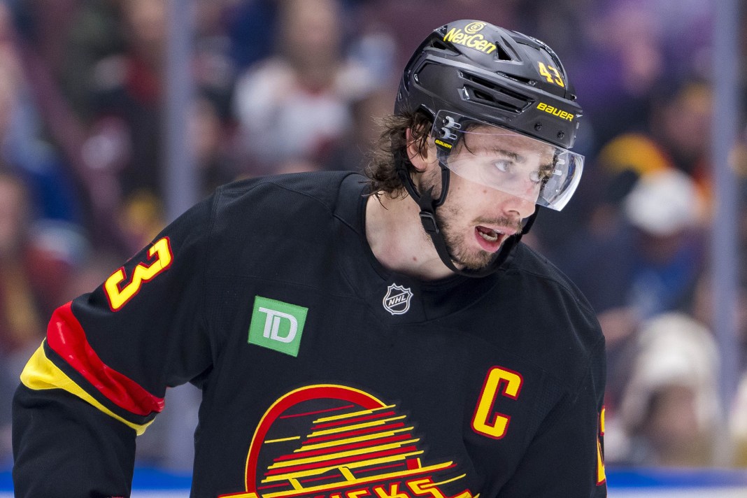 Vancouver Canucks defenseman Quinn Hughes (43) pauses during a stoppage in play against the Ottawa Senators in the third period at Rogers Arena on December 21, 2024