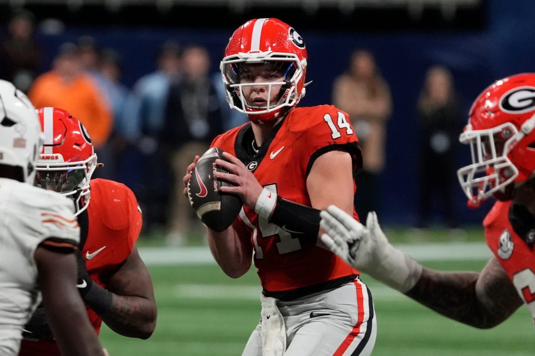Georgia quarterback Gunner Stockton (14) prepares to throw a pass during overtime of the SEC Championship game against Texas in Atlanta on December 7, 2024