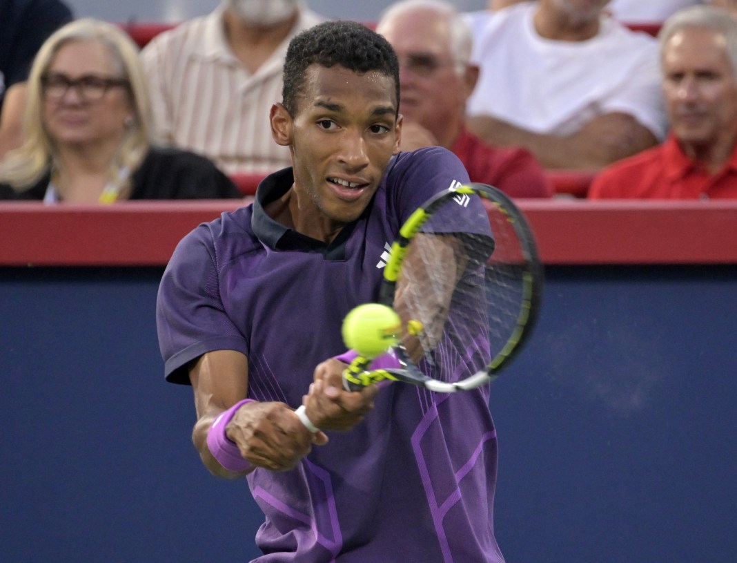 Felix Auger Aliassime hits a backhand against Flavio Cobolli in Montreal in 2024.