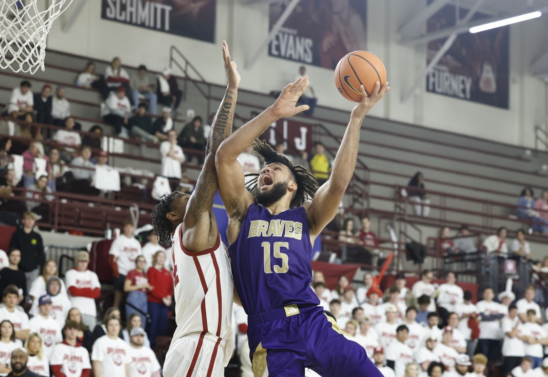 Alcorn State Braves forward Djahi Binet (15) drives to the basket while Oklahoma Sooners forward Jalon Moore (14) defends during the second half at Lloyd Noble Center on December 7, 2024