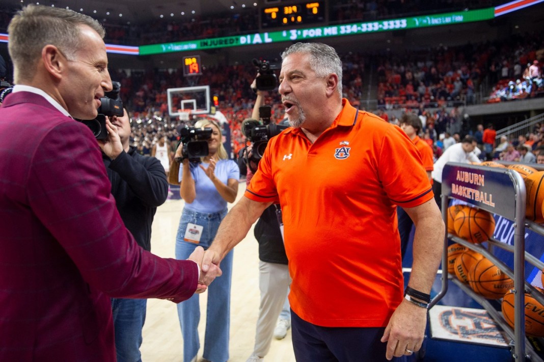 Alabama coach Nate Oats (left) and Auburn coach Bruce Pearl shake hands before a game at Neville Arena on February 7, 2024.