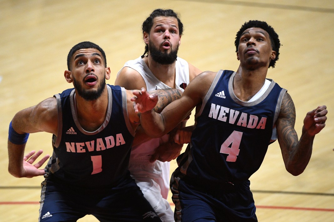 Nevada Wolf Pack forward Robby Robinson (1) and guard Desmond Cambridge Jr. (4) box out San Diego State Aztecs guard Jordan Schakel (20) during a free throw in the second half at Viejas Arena on January 9, 2021.