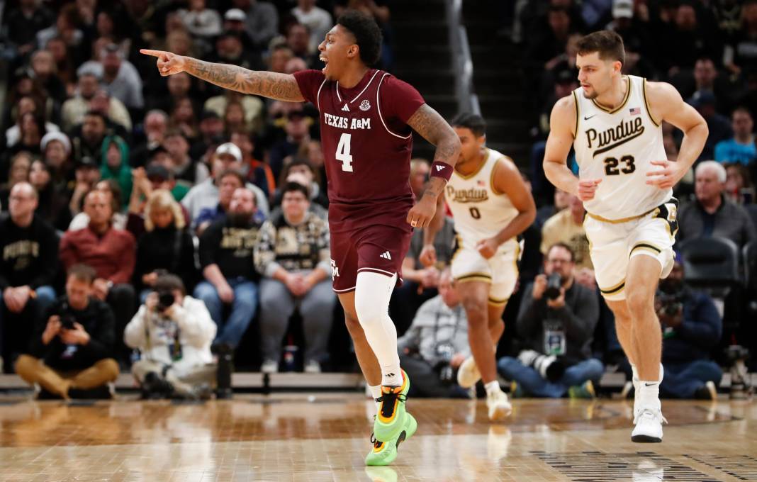 Texas A&M Aggies guard Wade Taylor IV (4) celebrates after scoring during the NCAA men’s basketball game against the Purdue Boilermakers at Gainbridge Fieldhouse in Indianapolis on December 14, 2024. Texas A&M won 70-66.