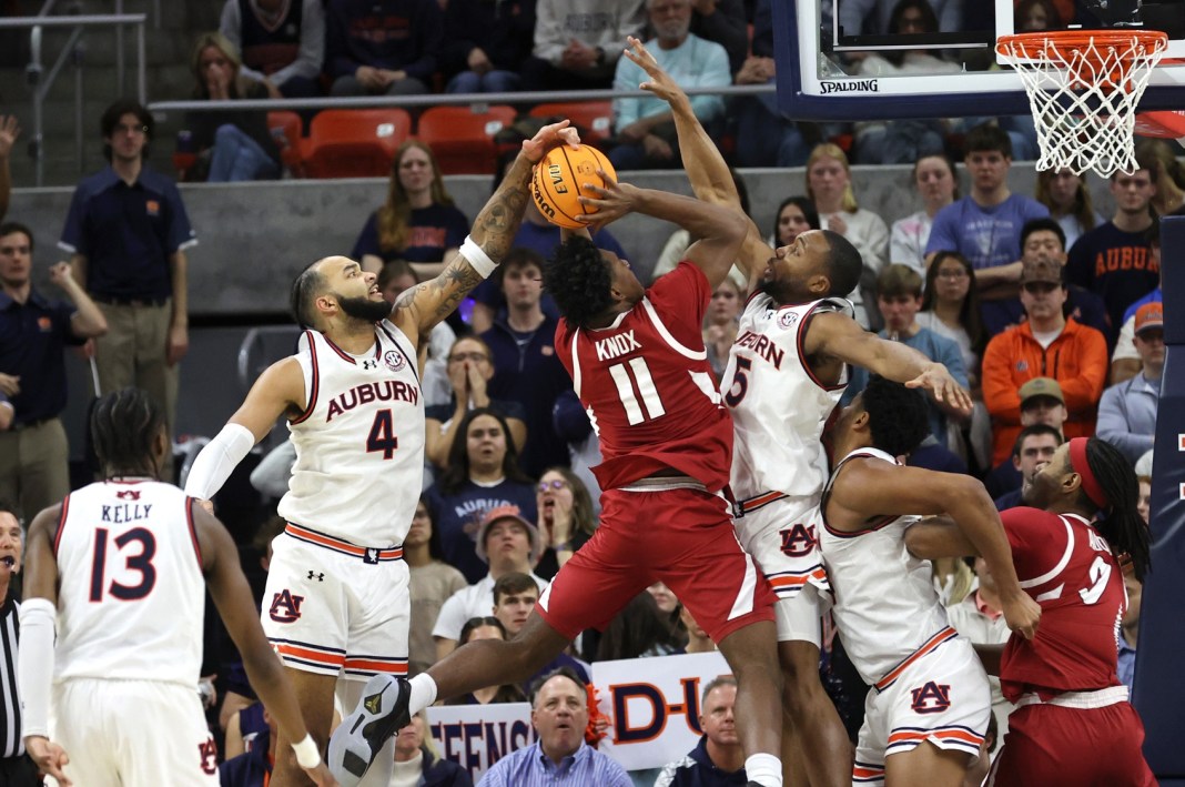 Auburn Tigers forward Johni Broome (4) tries to block the shot of Arkansas Razorbacks forward Karter Knox (11) during the second half at Neville Arena on February 19, 2025.