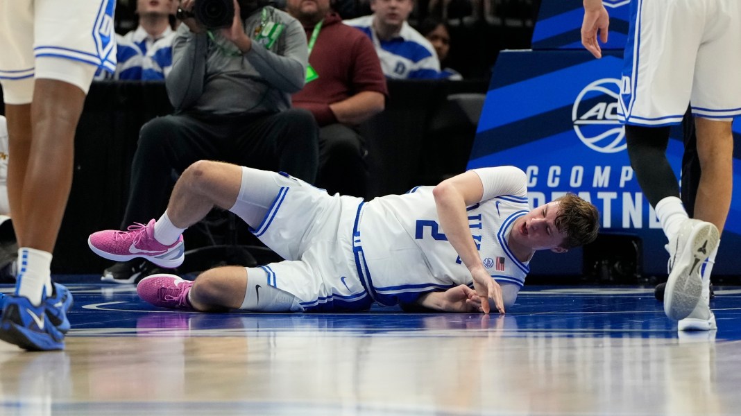 Duke Blue Devils forward Cooper Flagg (2) is injured in the first half at Spectrum Center on March 13, 2025.