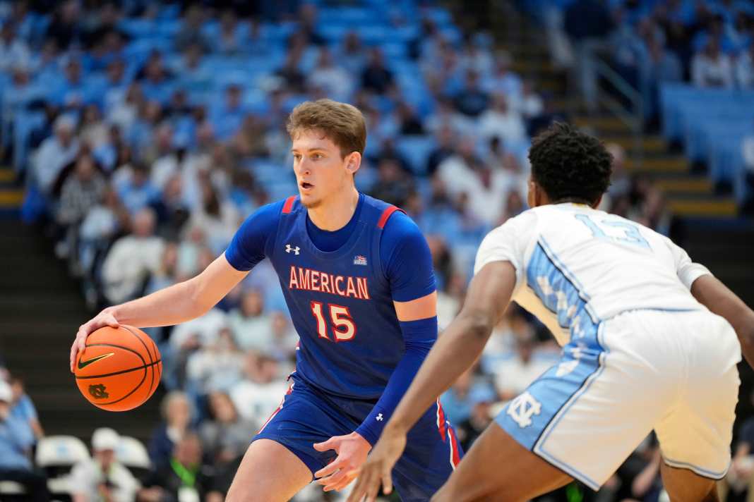American University Eagles forward Matt Rogers (15) handles the ball while North Carolina Tar Heels forward Jalen Washington (13) defends during the first half at Dean E. Smith Center on November 15, 2024.