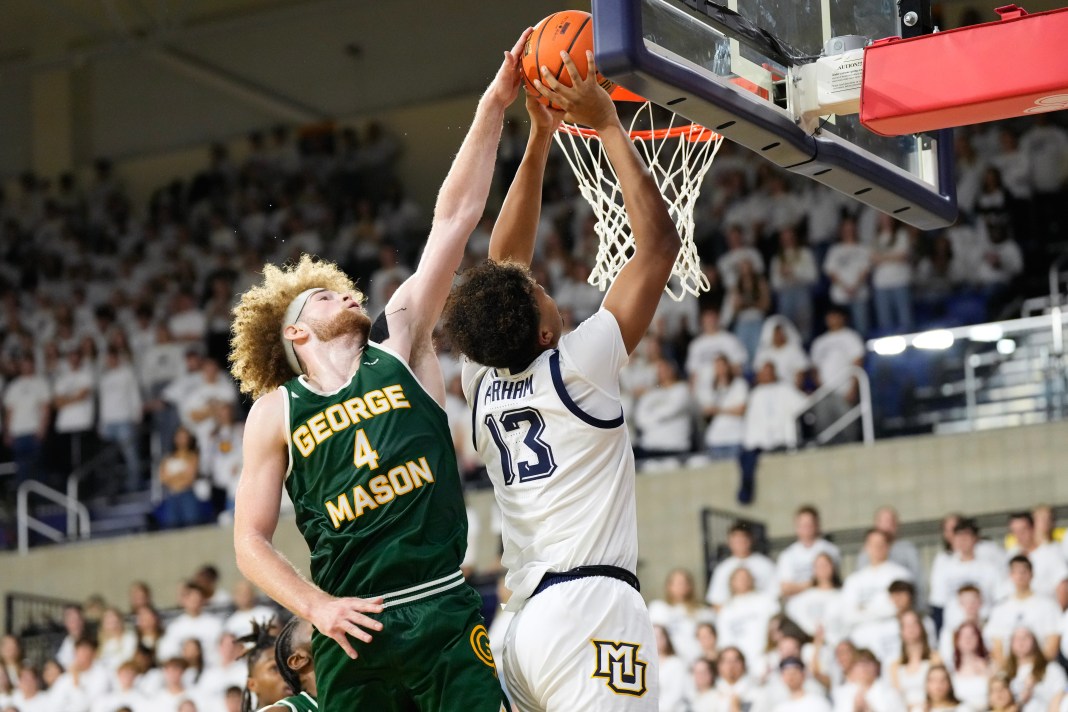 George Mason Patriots guard Brayden O'Connor (4) defends Marquette Golden Eagles forward Royce Parham (13) during the second half at Al McGuire Center on November 8, 2024.
