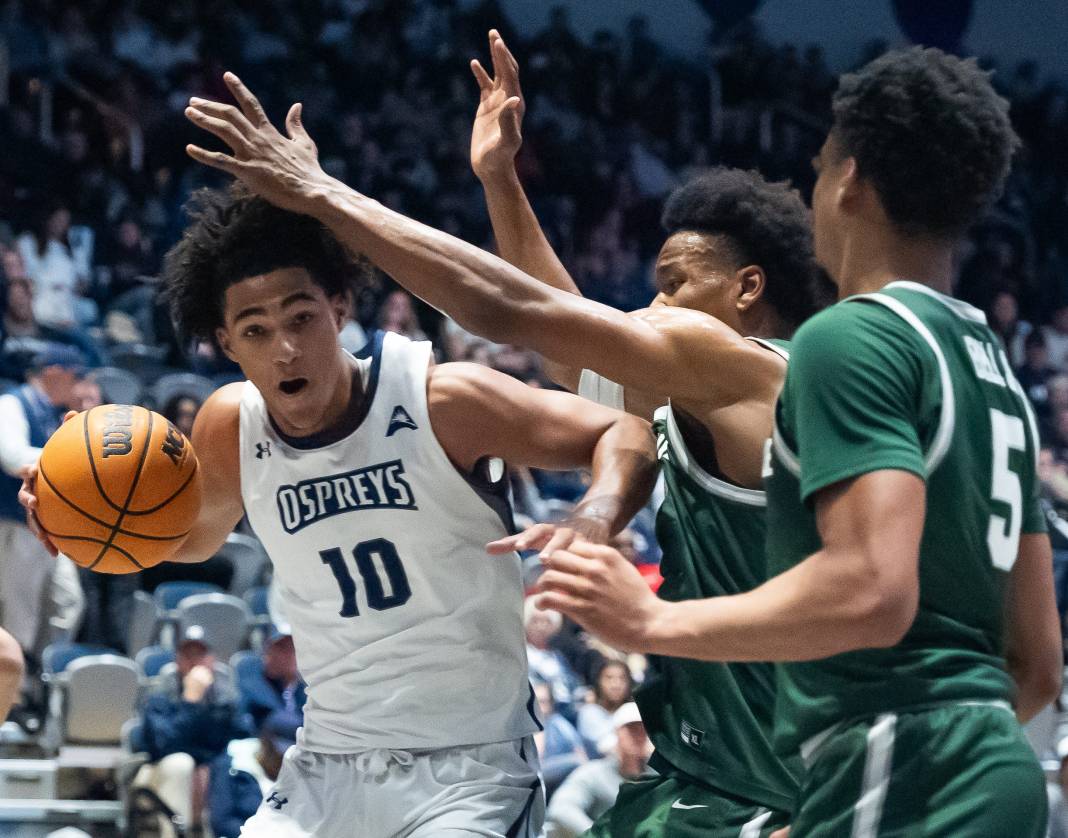 North Florida Ospreys guard Jasai Miles (0) is pressured by the Jacksonville University (JU) defense during the River City Rumble on February 20, 2025, in Jacksonville, FL. JU led 35-34 over UNF at the half.