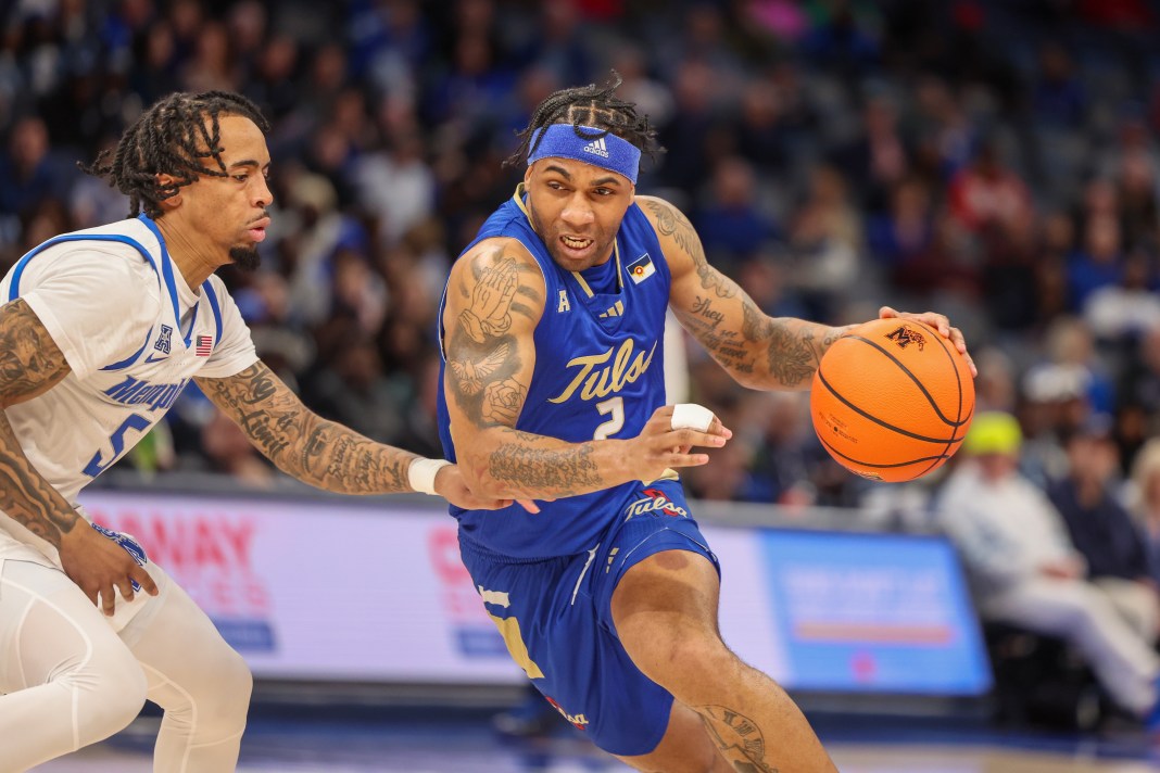 Tulsa Golden Hurricane guard Dwon Odom (2) drives against Memphis Tigers guard Dante Harris (5) during the second half at FedExForum on February 5, 2025.