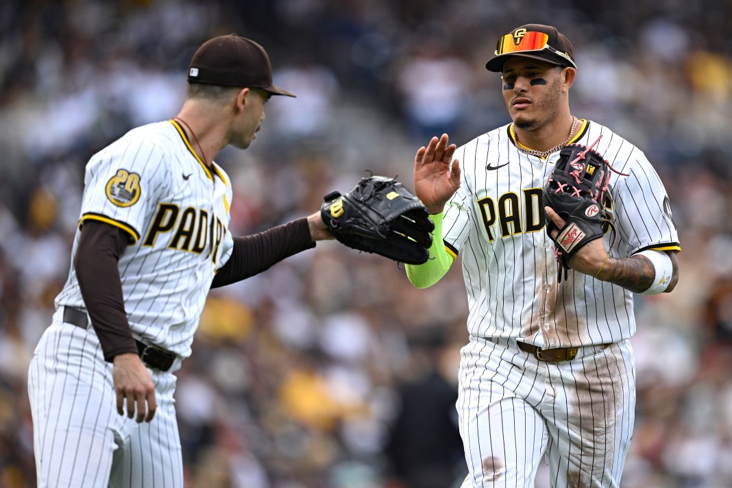 San Diego Padres third baseman Manny Machado (right) is greeted by starting pitcher Dylan Cease (left) after a defensive play against the Houston Astros during the third inning at Petco Park in San Diego, California, on September 18, 2024.